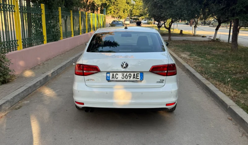 Volkswagen Jetta 2015 2.0 TDI Automatic - Comfortable Diesel Sedan Rental in Albania 46 - Car Rent in Albania White Volkswagen Jetta 2015 2.0 TDI automatic diesel sedan parked in Tirana, available for car rental in Albania with TiRental